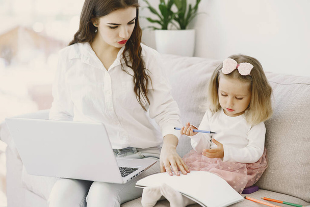 Woman with daughter using laptop computer - Φωτογραφία, εικόνα