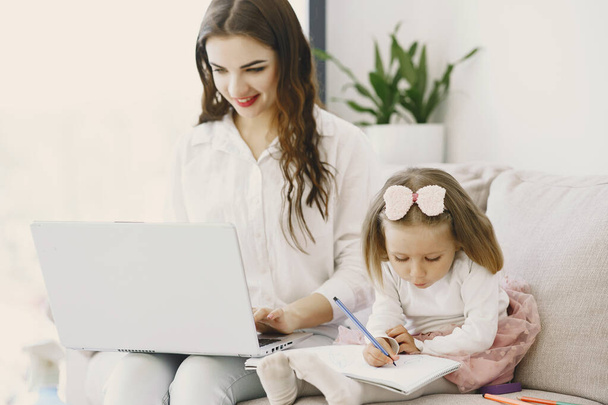 Woman with daughter using laptop computer - Foto, afbeelding