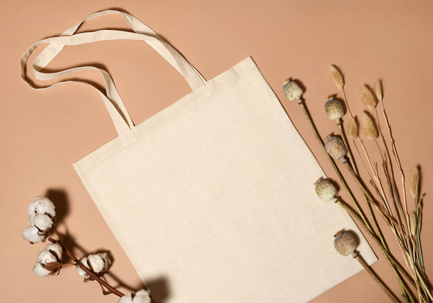Beige cotton tote bag with died plants for mock up - Фото, изображение