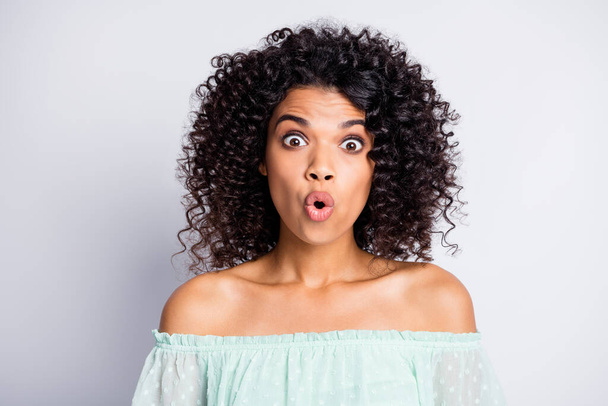 Portrait of young afro attractive beautiful shocked amazed surprised woman girl female look in camera isolated on grey color background - 写真・画像