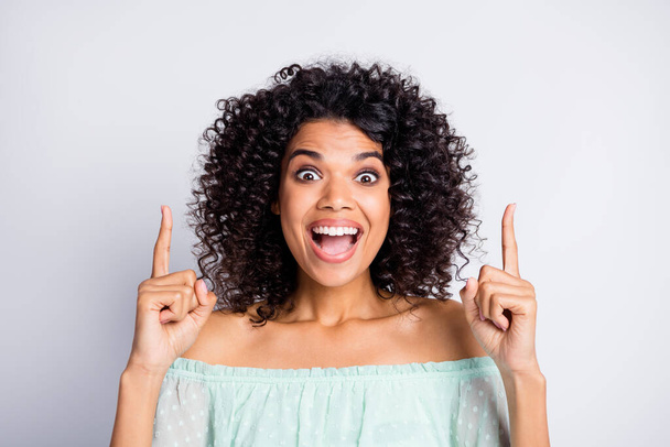 Photo portrait of screaming woman pointing two fingers up at blank space isolated on white colored background - Zdjęcie, obraz