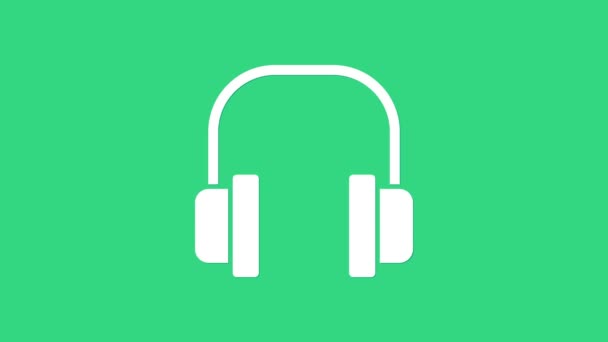 Fehér fejhallgató ikon elszigetelt zöld háttérrel. Fülhallgató. Koncepció zenehallgatáshoz, szolgáltatáshoz, kommunikációhoz és operátorhoz. 4K Videó mozgás grafikus animáció - Felvétel, videó