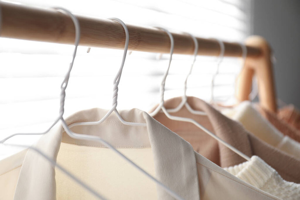 Rack with stylish women's clothes indoors, closeup. Modern interior design - Zdjęcie, obraz