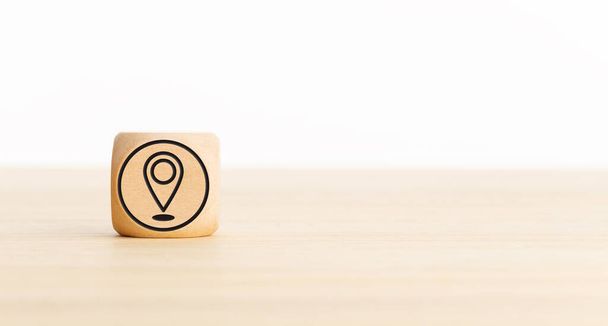 Pin Location Icon on wooden block. Copy space. White background - Photo, Image