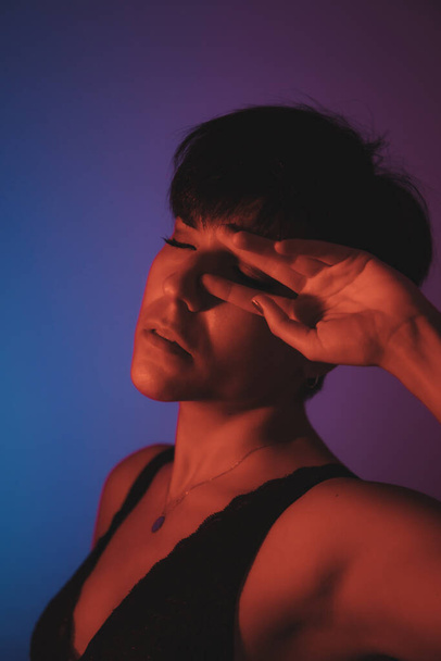 Värikäs muotokuva naisen silmät koskettaa hänen silmäänsä studiossa - Valokuva, kuva