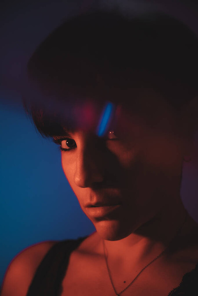 Colorful portrait of a woman with short hair in studio looking at camera - Фото, зображення