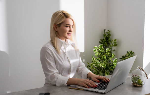 Happy Young Beautiful Woman Using Laptop, Indoors on white wall background - Φωτογραφία, εικόνα