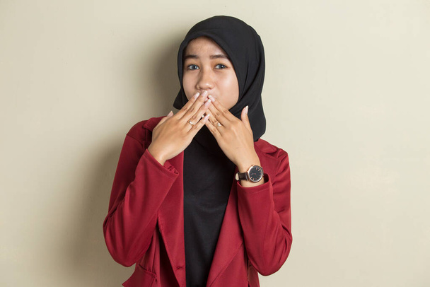 Jonge Aziatische vrouw draagt hijab geschokt bedekken mond met handen voor fout. Geheim concept. - Foto, afbeelding