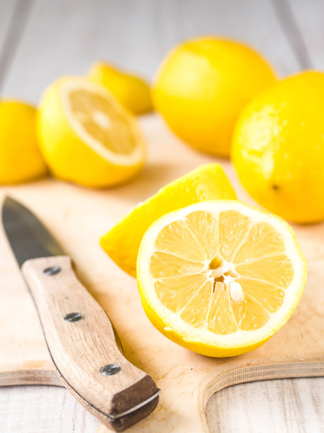 Fresh lemons on cutting board - Фото, зображення