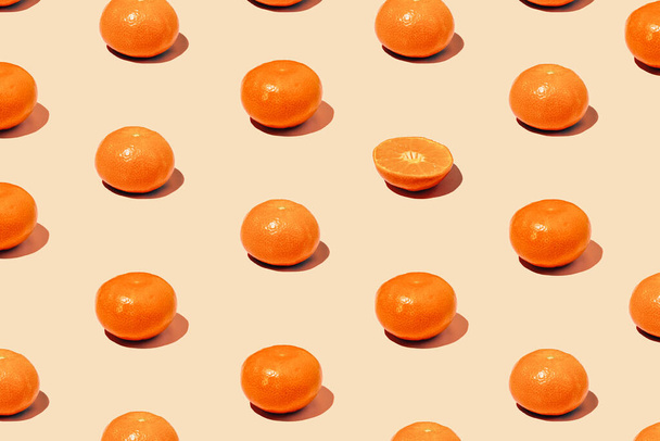 Monochromatic creative pattern made of fresh tangerine in diagonal. Juicy citrus on Set Sail Champagne background. Minimal concept - Фото, зображення