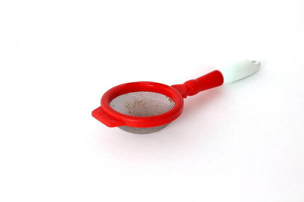 Red plastic tea strainer isolated on white background - Photo, Image