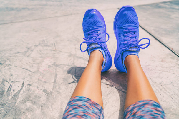 Running shoes fashion activewear healthy active people lifestyle. Selfie woman taking pictures of royal blue trainers during workout at gym floor outside - Photo, Image