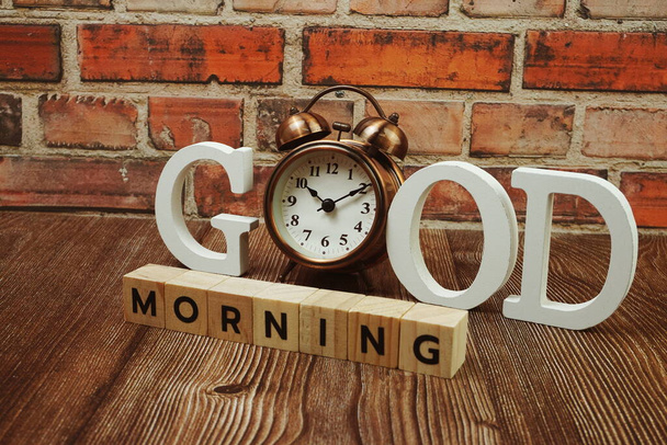 Good Morning alphabet letters with alarm clock on wooden background - Φωτογραφία, εικόνα