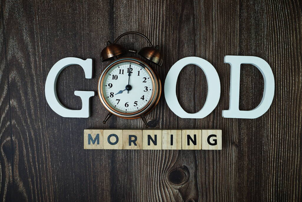 Good Morning alphabet letters with alarm clock on wooden background - Fotoğraf, Görsel