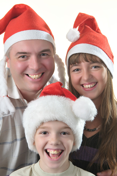 Vrai homme avec des enfants en chapeaux Santas
 - Photo, image
