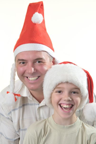 Батько і син є в шапках Санта Клауса - Фото, зображення