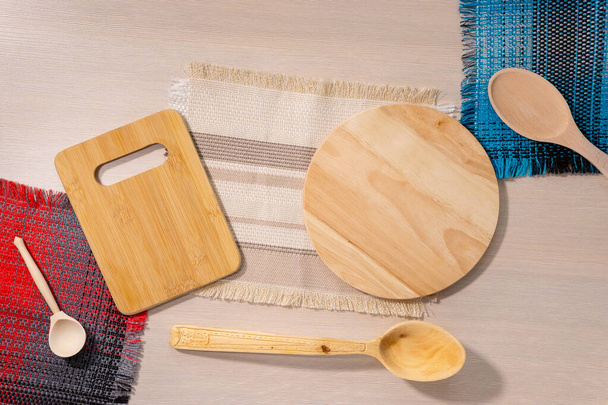 light wooden background, wooden Cutlery - a wooden spoon and cutting boards. top view flat lay - Photo, Image