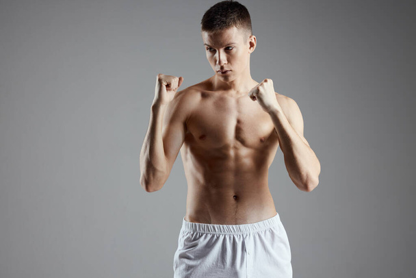 guy are boxing on gray background and naked torso muscle bodybuilder  - Valokuva, kuva