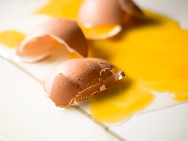 A closeup shot of broken eggs on a white background - Fotografie, Obrázek