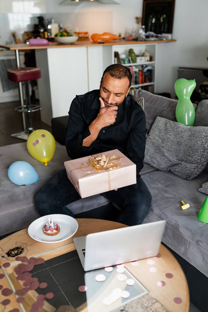 Mature man chatting with his family through internet during his birthday - Foto, Imagem