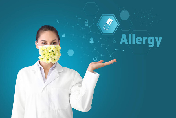 Portrait of female doctor in protective mask with flowers using virtual screen on color background. Concept of allergy - Фото, изображение