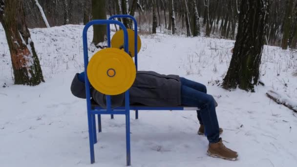 Atletik vücut geliştirme eğitimi kış günü halterleri kaldırıyor. Sakallı adam vücudunun üst kısımları üzerinde çalışarak güç egzersizleri yapıyor. Fitness, sağlık, sağlıklı spor yaşam tarzı. Ağırlık kaldırma ağırlık kaldırma - Video, Çekim