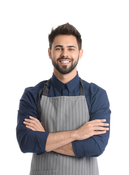 Young man wearing apron on white background - Foto, afbeelding