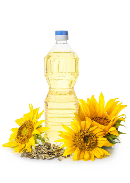 Bottle of oil, seeds and sunflowers on white background - Foto, immagini