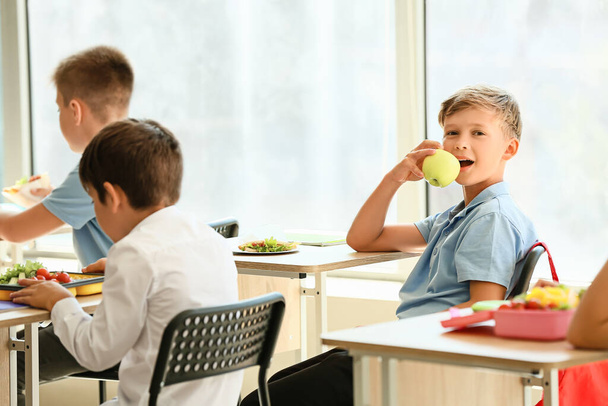 Pupils having healthy lunch in classroom - Photo, Image