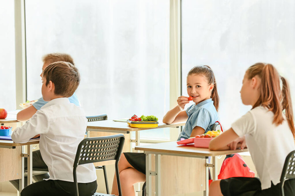 Schüler essen gesundes Mittagessen im Klassenzimmer - Foto, Bild