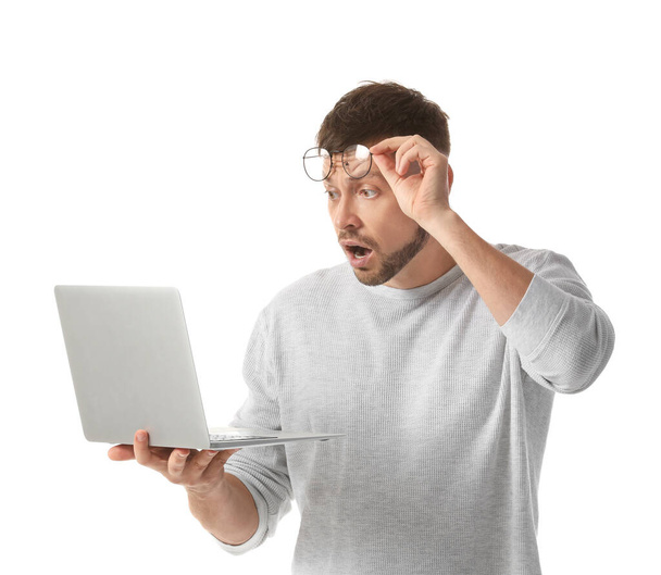 Stressed man with laptop on white background. Concept of deadline - Fotó, kép