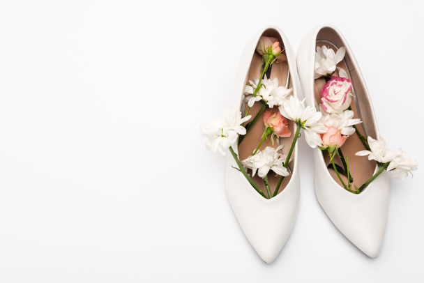 flowers in female shoes isolated on white - Photo, Image