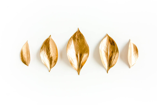Pattern, texture with gold leaves isolated on white background. flat lay, top view - Foto, imagen