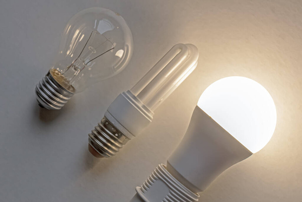 Incandescent bulb, fluorescent bulb, led bulb, next to each other. Technological evolution of light bulbs. - Photo, Image