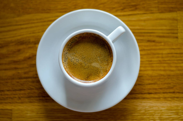 close-up of a cup of coffee high point view on wooden background - Foto, Imagen