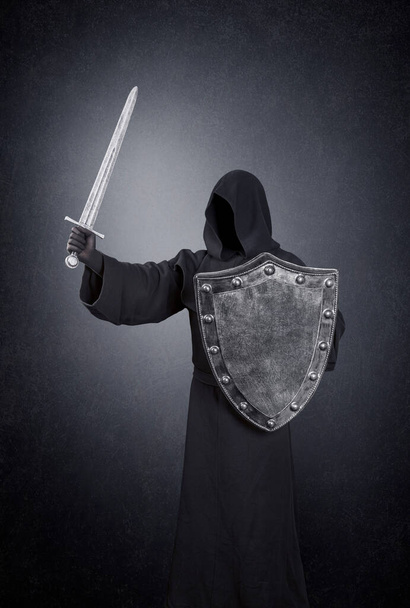 Ghostly figure with medieval sword and shield in the dark - Foto, imagen