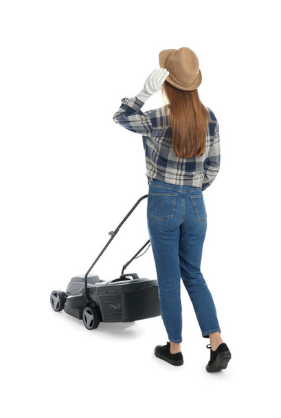 Young woman with modern lawn mower on white background, back view - Foto, Imagem