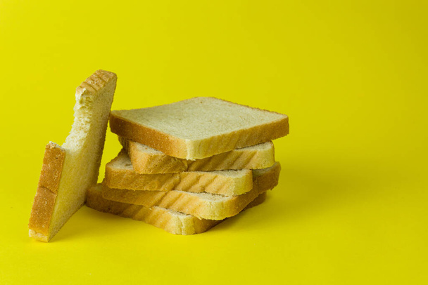 Toast bread on yellow background side view - Fotoğraf, Görsel