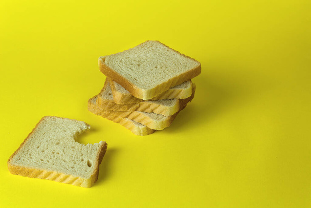 黄色い背景色のパン - 写真・画像