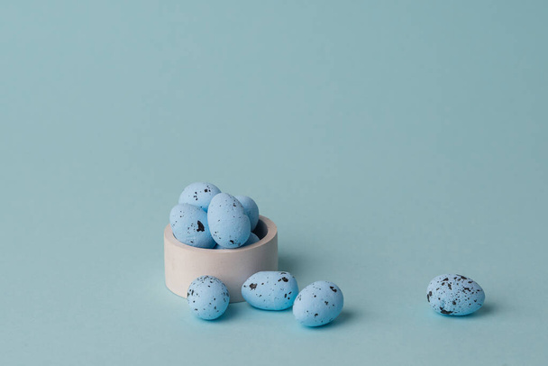 quail blue easter eggs on blue background. Minimal comcept with copy space. spring holidays decor - Zdjęcie, obraz