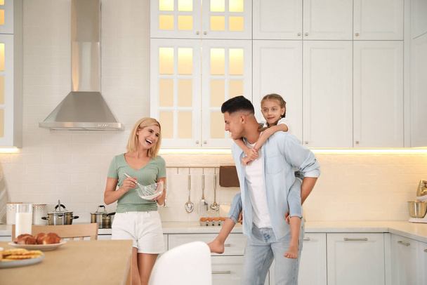 Happy family cooking together in modern kitchen - Photo, image