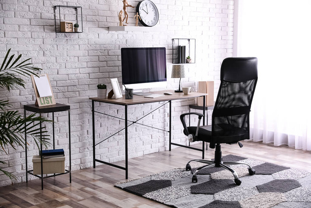 Comfortable chair near desk in modern office interior - Fotó, kép