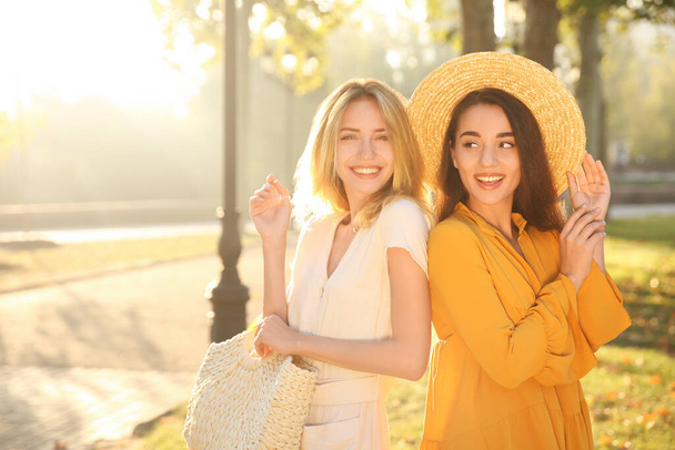 Beautiful young women in stylish dresses outdoors - Zdjęcie, obraz