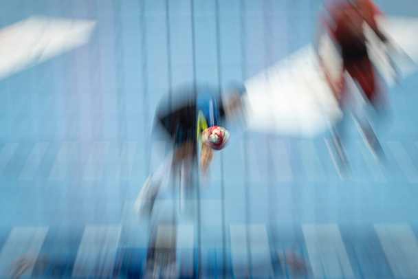 Handball ball thrown by player - intentional blurred by long exposure. - Photo, Image