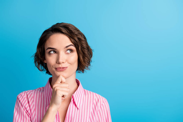 Photo of curly cheerful thoughtful cute lady dressed casual outfit arm finger chin look empty space isolated blue color background - Zdjęcie, obraz