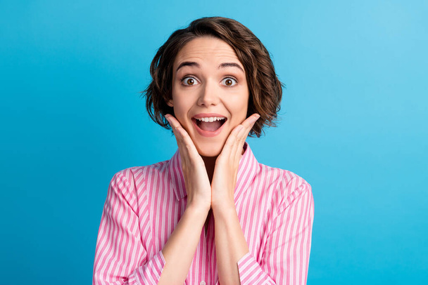 Photo portrait of cute charming business lady dressed formal pink shirt open mouth arms cheekbones isolated blue color background - Фото, изображение