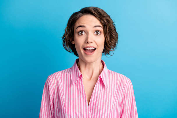 Photo portrait of curly cute surprised business woman lady wear pink shirt open mouth isolated blue color background - Fotó, kép