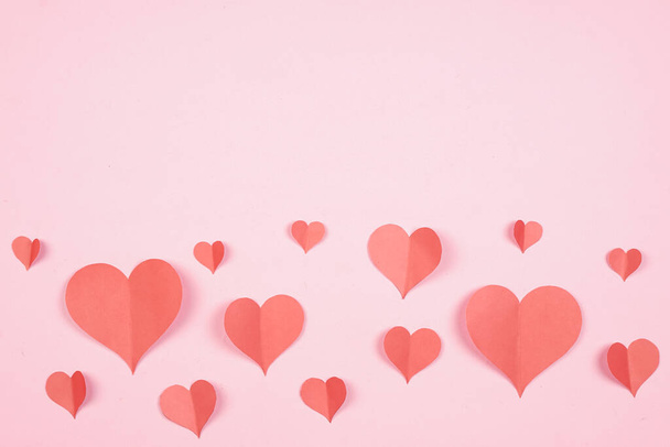 Heart shaped paper sticked on pink background. Emblem of love for happy women, beloved mother, birthday cards and valentine greeting designs. Valentine's day backgrounds. Templates to convey our love. - Foto, imagen