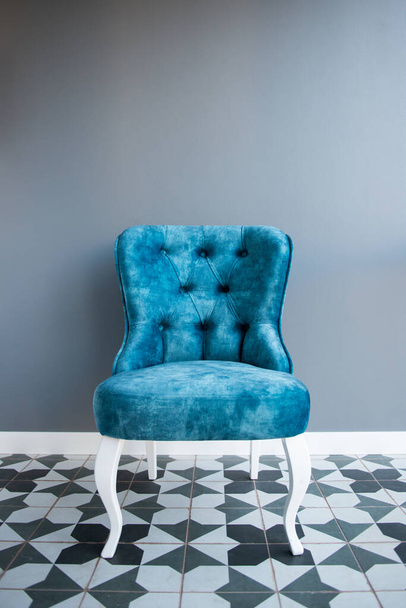 Modern design home interior with elegant blue chair in retro style over gray wall. Stylish home decor - Foto, Imagem