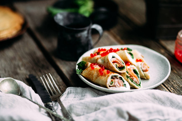 pancakes with fish, red caviar and cream cheese - Photo, Image